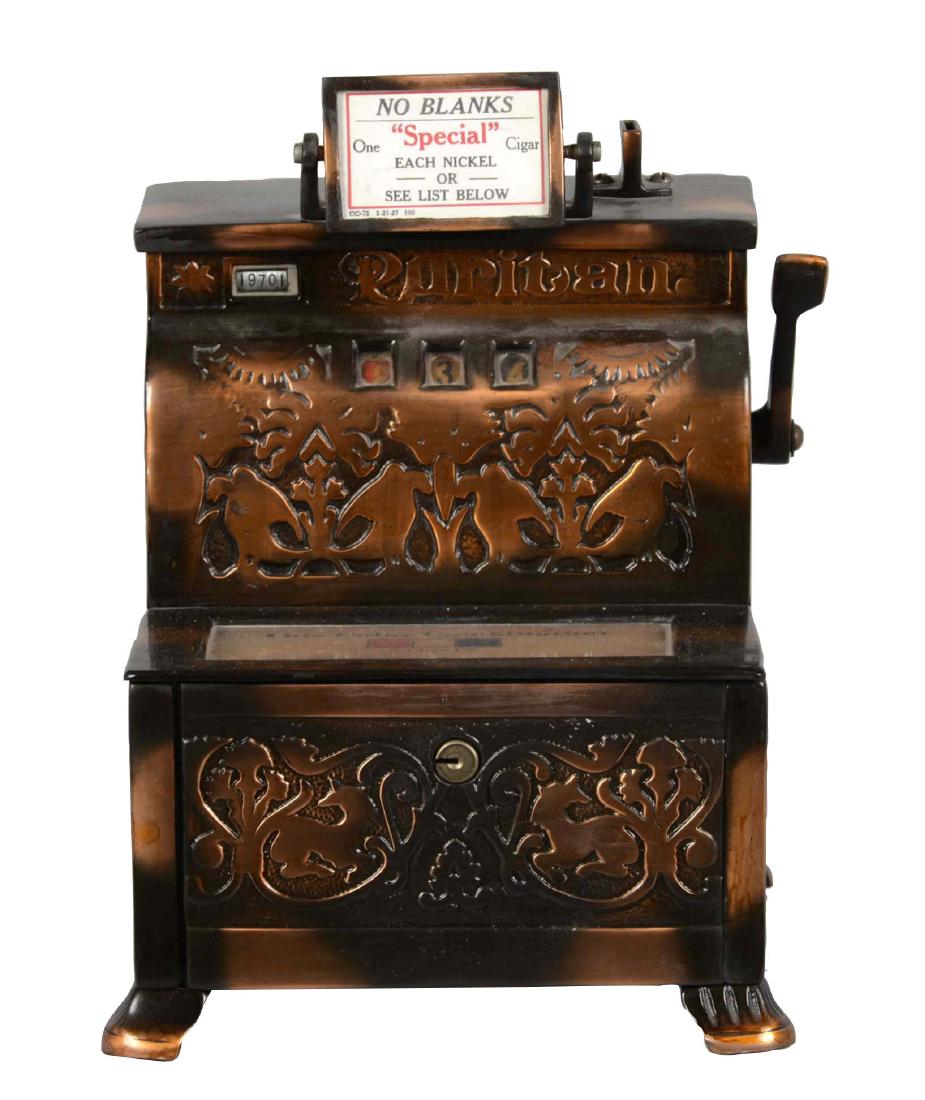 **5¢ Mills Imperial Puritan Trade Stimulator: Mills Novelty Co manufactured this machine about 1905. This version has a cast aluminum cabinet with a copper flash finish and three reels with red, white, and blue numbers that determine how many cig
