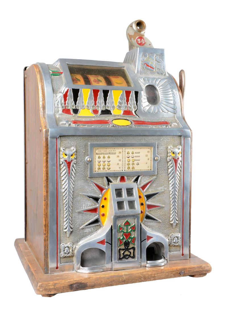 **5¢ Mills Operators Bell Slot Machine: This machine appears to have an older restoration and displays wear, especially on the wood base. Has original reel strips and award card. In working condition. Circa 1923. Includes 1 key. (Very Good)