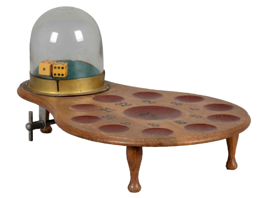 Dice Game Monaco: Wooden game board with 11 red wells to place bets and clear glass dome with dice inside. The knob on the underside shakes the dice when turned. Instructions for game play are posted on the underside o