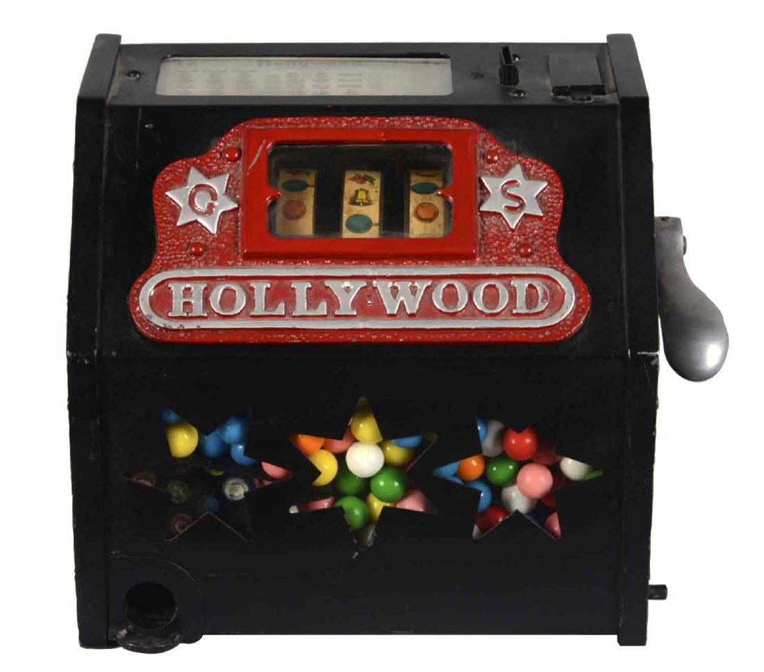 **1¢ Giles & Simkins Hollywood Trade Stimulator: This three reel countertop machine features star shaped cutouts to show gumballs. Awards card shows fortune rewards. In working order with evidence of an older restoration. Circa 1930. Includes key. (