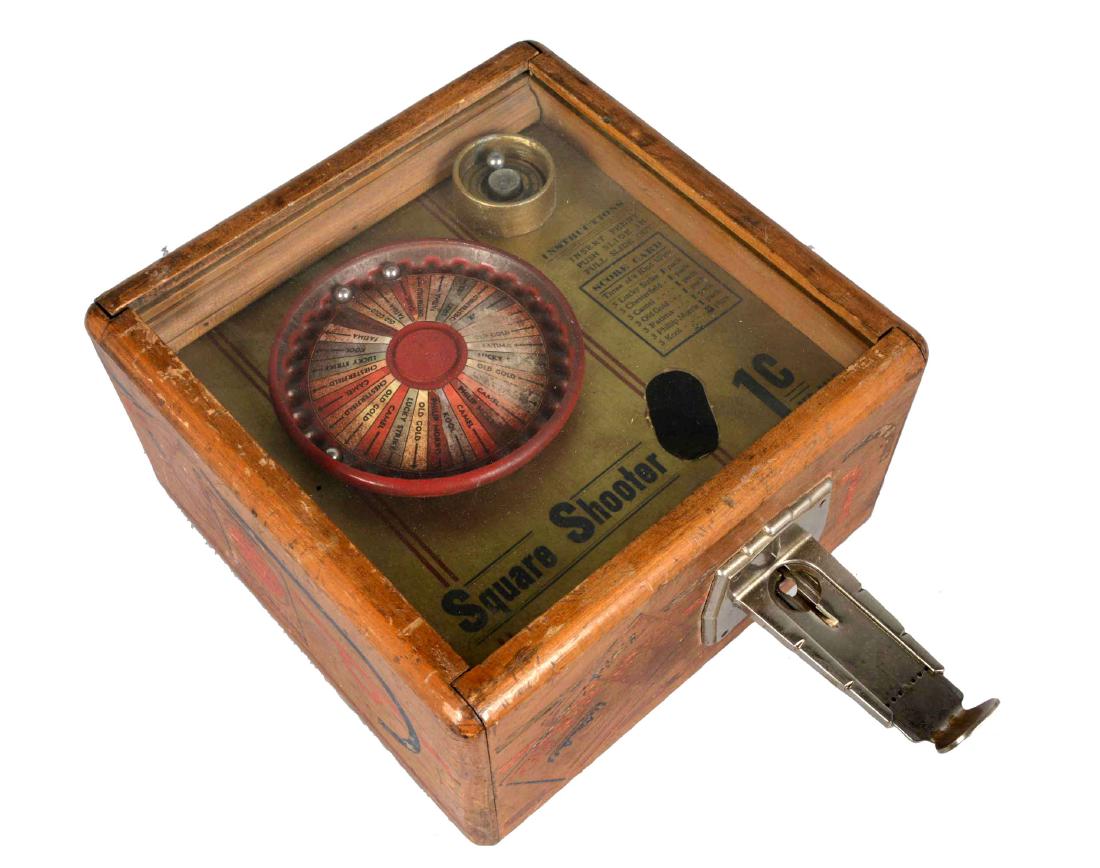 **1¢ Star Mfg. Square Shooter Trade Stimulator: This countertop trade stimulator is similar in design to a roulette wheel but has three balls instead of one. If players spun three of a kind they won packs of cigarettes. Worn throughout and requires