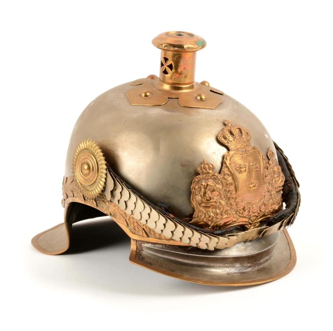 Swedish Pickelhaube Style Helmet.: Helmet with brass flower base. No pike. Plate with two lions, crown and shield. White metal chinscales with one retainer only. Missing sweatband. Shows small dents and pitting.