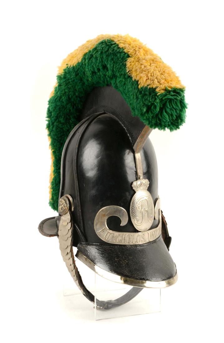 1875 Bavarian Leather Helmet.: Black leather Bavarian helmet with green and yellow crest. Silver plate with "R" and crown. Reading "FUR CHTLOS UND TREW". White metal-scale chin strap (adjusting portion of strap replaced), die-struc