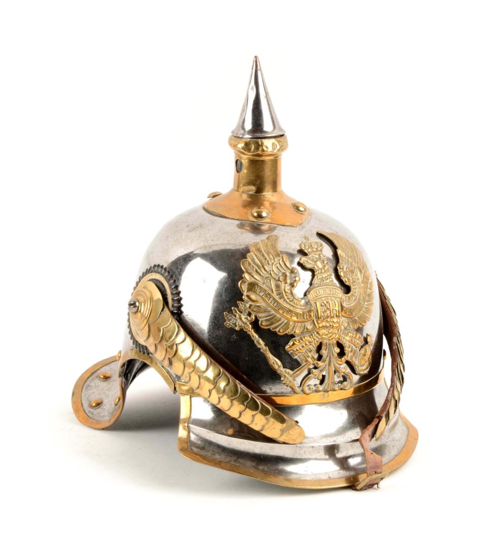 Prussian Cuirassier Pickelhaube M1889: Polished steel body, front and rear visors with all lower edges of helmet reinforced with brass edging and rivets. Brass spike base with steel spike. Stamped brass front plate of a Prussian eagle with