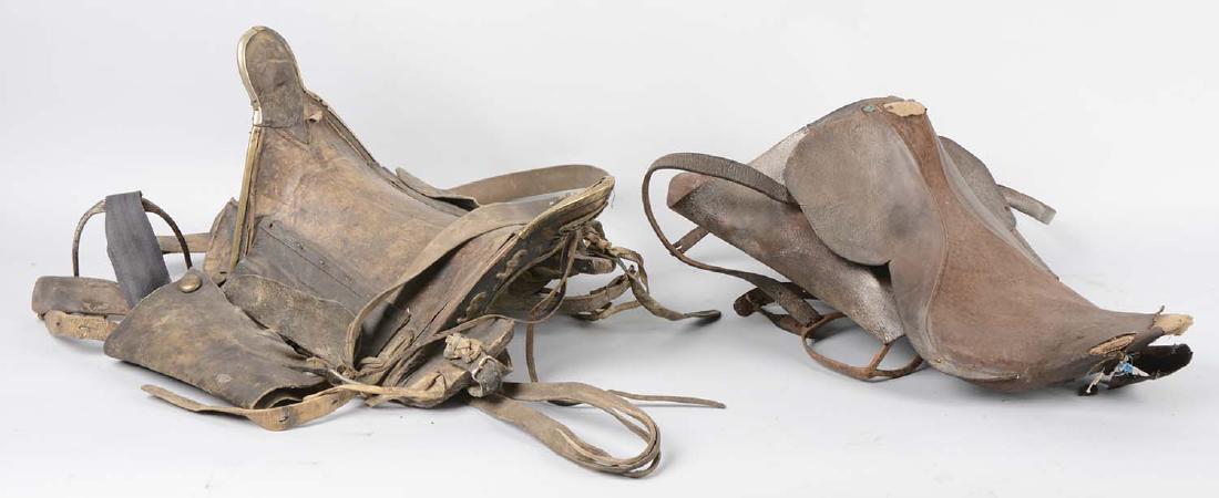 Lot Of 2: Military Saddles.: Including a leather military saddle with a wooden tree, it has both spar and leather strap. Shows damage to leather, well used. The second item is an early 19th century officer's leather saddle. It ha