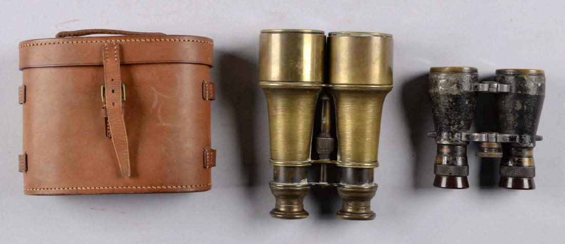Lot of 2: Optical Items With Case.: Comprised of: 1) Pair of French field glasses [dented], Brass construction. 2) Pair of German field glasses [chipped], need cleaning. 3) British leather binocular case. No strap. All showing light age