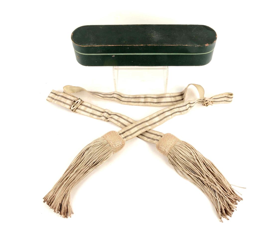 Prussian Officer's Parade Sash in original box: Imperial German (Prussian) commissioned officer's parade sash consisting of a long strap of 1 11/16 inch-wide, silver lace with two black lines, with white webbing tape underside, ending in broad Turk