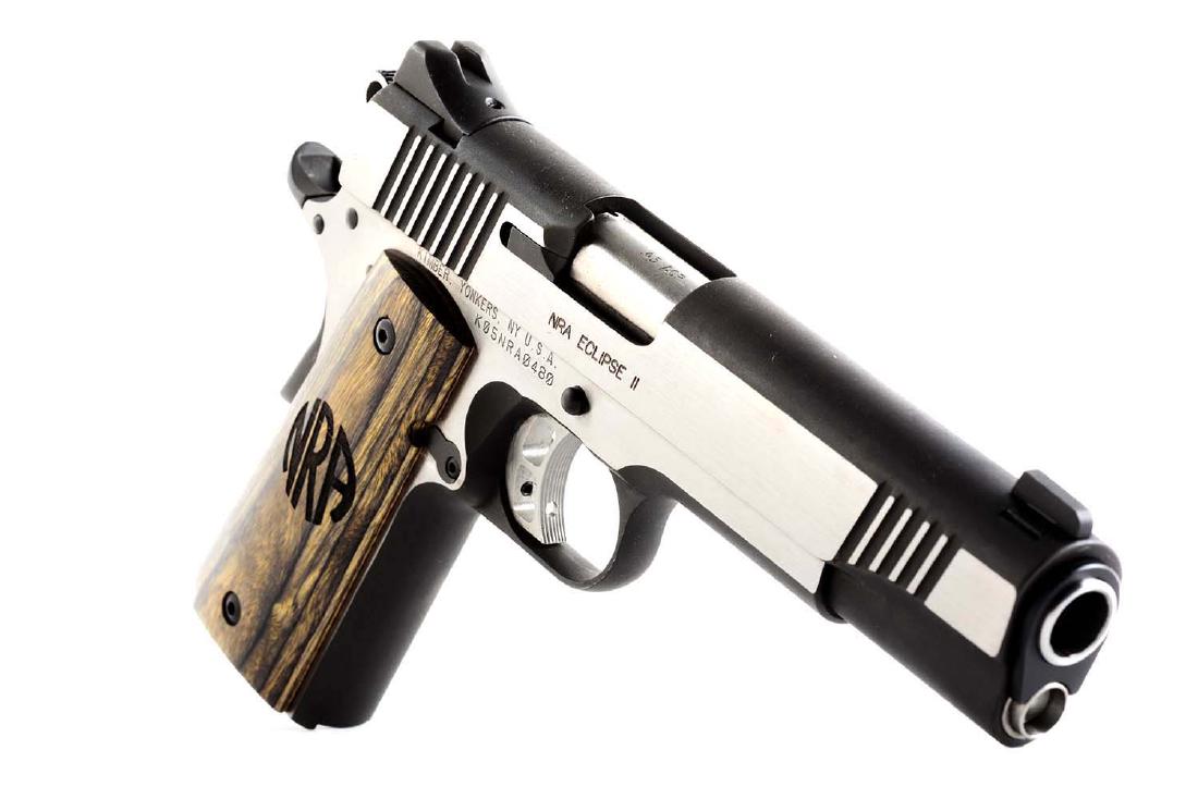 (M) Cased Kimber NRA Model 1911 Semi-Automatic Pistol.: Manufactured in 2005 as the NRA Gun of the Year. Referred to as the NRA Eclipse II. The basic design is the Colt Model 1911. Matte/brushed stainless finish, NRA logo wood grips and Novack style combat