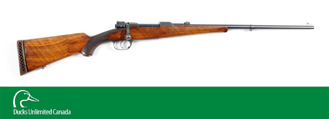 (C^) Commercial Mauser Bolt Action Sporting Rifle.: Features of this factory Mauser sporting rifle include ramp front sight; three leaf rear sight; sling swivel on barrel band; single trigger; checkered pistol grip walnut stock with grip cap, straight 