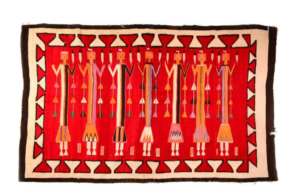 Navajo Yei Rug.: Early 20th century, depicting Indian figures and feathers. This carpet has great brown, red, and purple colors in vibrant condition. There are a few areas of loss and fraying. There are a few small ar