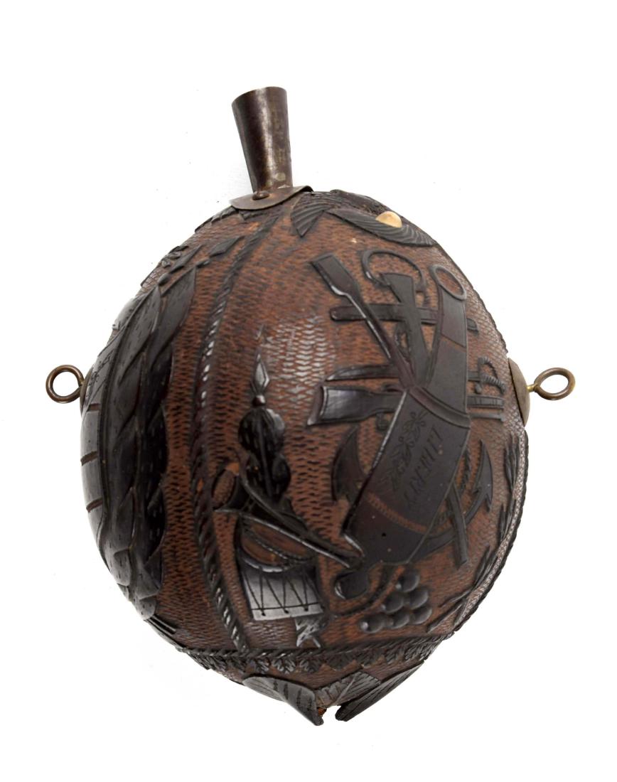 Patriotic Folk Art Coconut Powder Flask with: A great piece of maritime Americana. This coconut probably dates to around 1819 based on the carving of the 21 star United States flag. The piece has dark color and is relief and incise carved. The mo