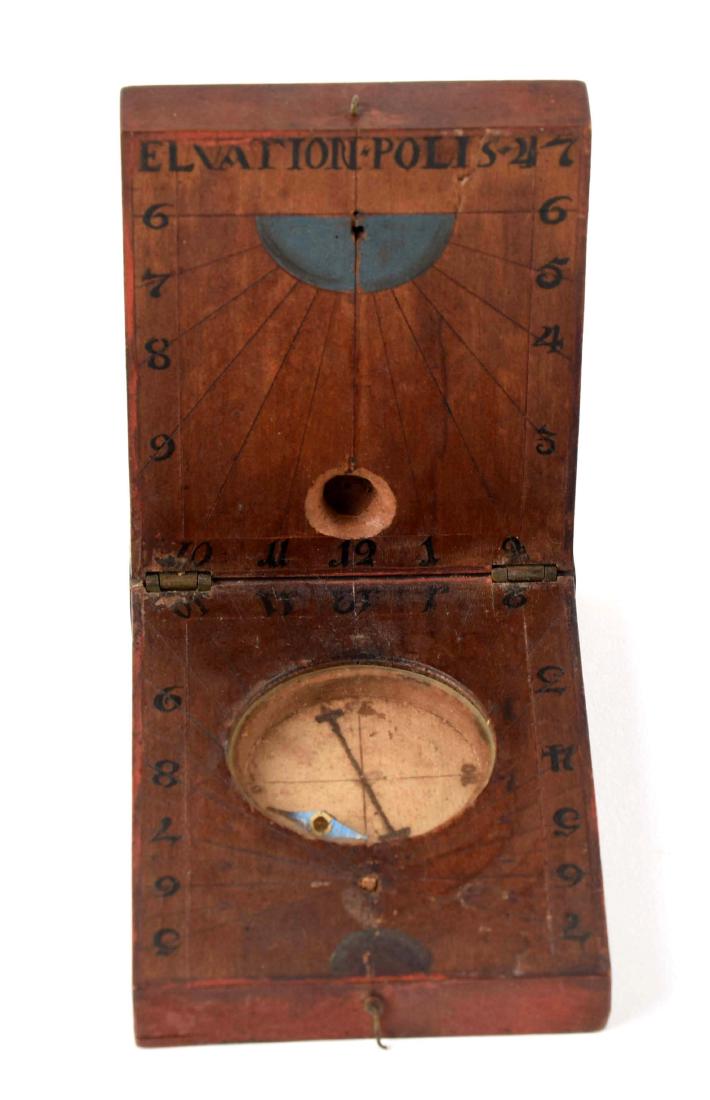 Revolutionary War Period Compass and Sun Dial.: Initialed by owner and painted red on the exterior. This combination of a compass, sundial, and elevation tool is a rare example. Made out of wood with manuscript drawing compass on laid paper and set