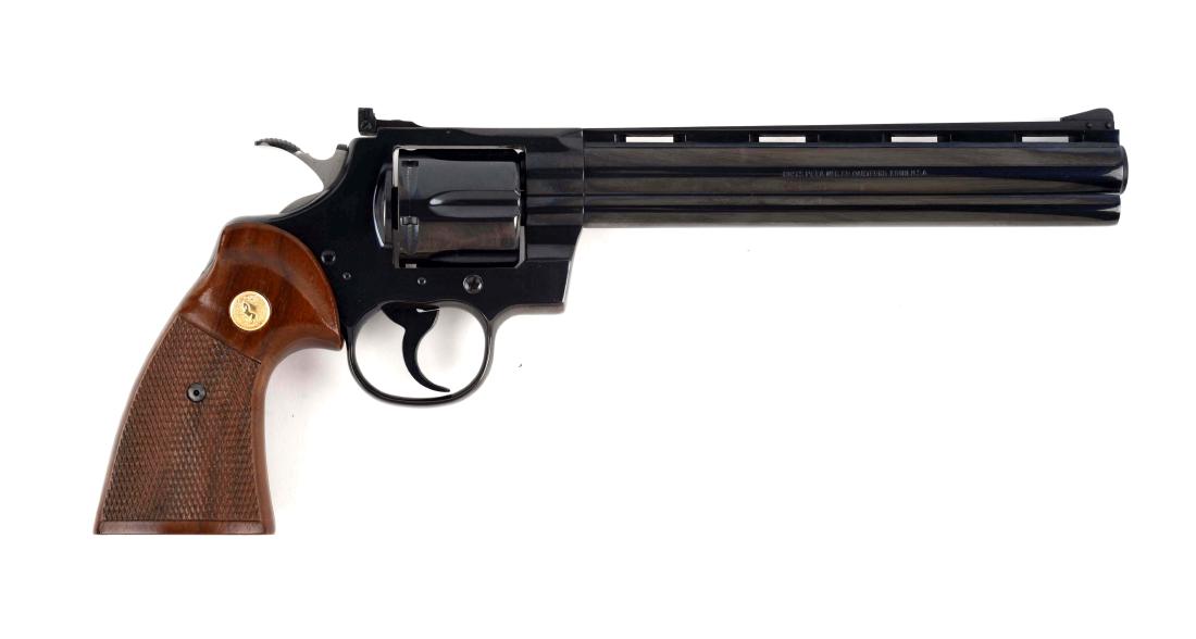 (M) Colt 8" Royal Blue Python Double Action Revolver.: Manufactured 1980. Standard features include full vent rib, adjustable sight, no outline, full royal blue finish, and Colt gold medallion third style walnut grips. Light drag line. Cylinder shows only