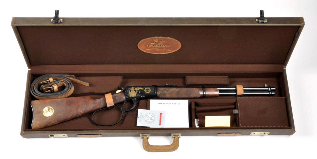 (M) MIB Winchester John Wayne Model 1892 Rifle.: This beautiful set comes with a mint in box rifle as well as an exquisite leather hard carry case which is lined in brown felt and the Winchester John Wayne logo in leather inside of lid. The rifle is