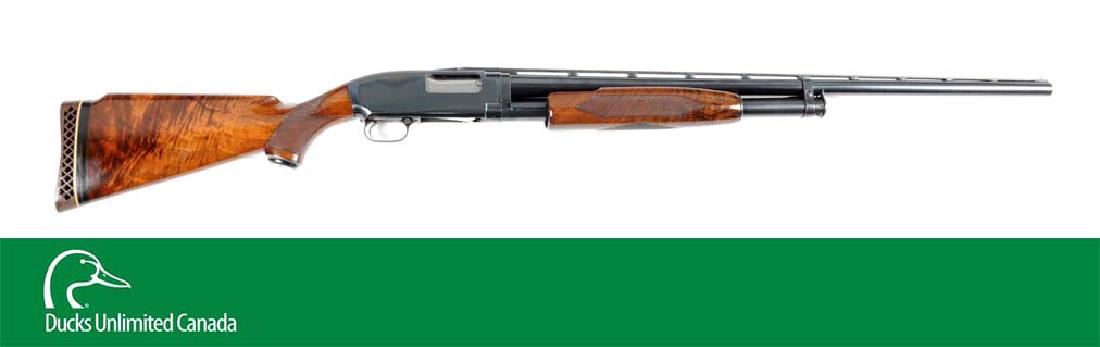 (C^) Winchester Pre-64 Model 12 Deluxe Slide Action: Manufactured 1961. Features full vent rib, matted, double bead, blued finish, takedown, deluxe checkered oil finish wood forend, fiery grain checkered pistol grip highly finish stock, metal grip cap a