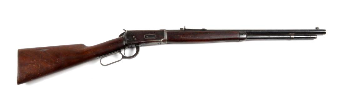 (C) Winchester Model 1894 Lever Action Rifle.: This rifle was manufactured in 1903. It is chambered for the .25-35 WCF cartridge. The octagon barrel has been shortened to 21-1/2", magazine has been set back, top of barrel has filler screws for tub