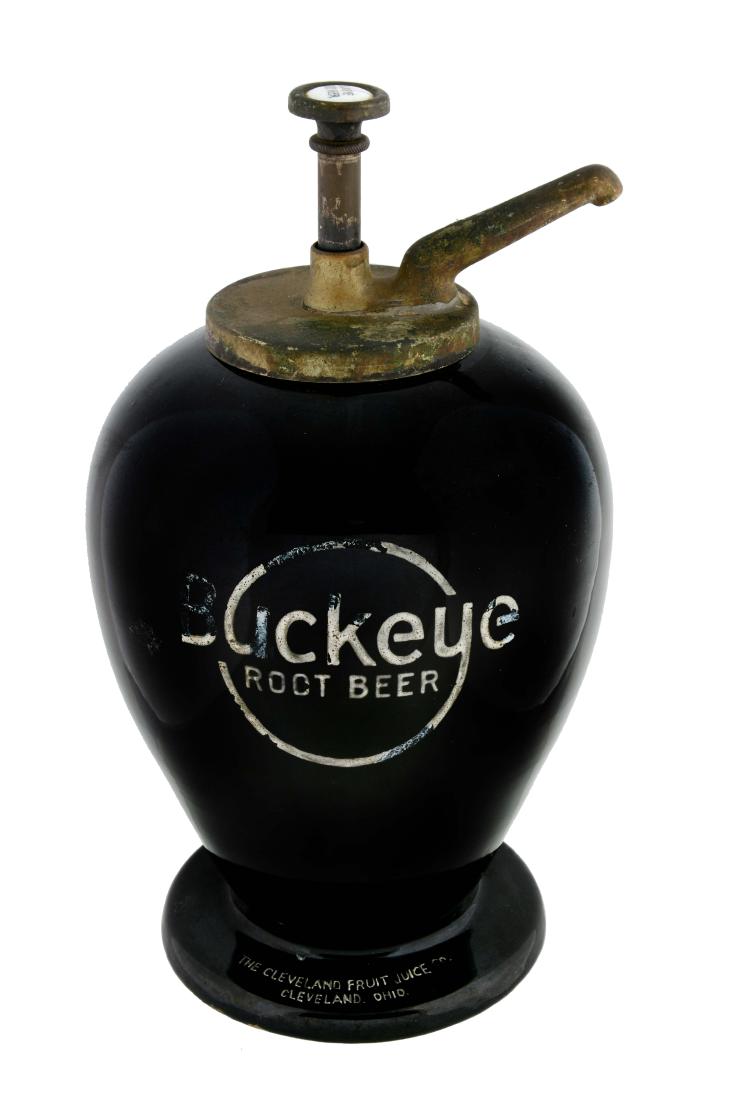 Buckeye Root Beer Syrup Dispenser.: Comes with a Buckeye Root Beer pump. There are some areas of loss and fading to the Buckeye logo on the front. Otherwise, the dispenser is in great condition. (Very Good Plus). 14" T.