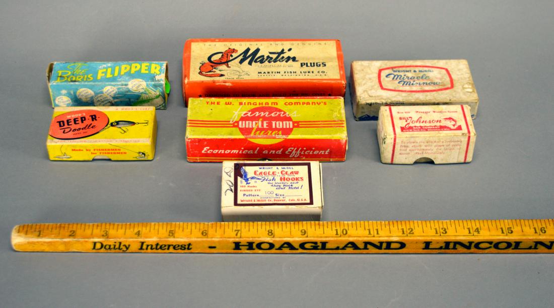 Seven empty fishing lure boxes: Including a Bill Johnson "Froggie," Eagle Claw Fish Hooks, W. Bingham "Uncle Tom," Wood's "Deep R" Doodle, Wright & McGill "Miracle Minnow," Martin Plugs, and "The Boris Flipper"