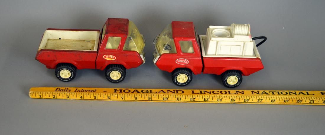 Two red Tonka trucks: Missing parts. Surface wear