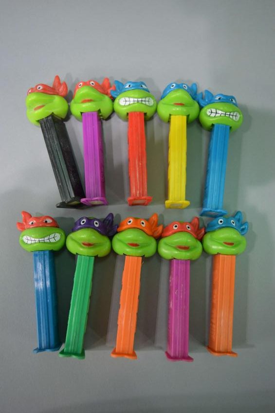 Assortment of Teenage Mutant Ninja Turtle PEZ: A large assortment of Teenage Mutant Ninja Turtle PEZ dispensers. Please review the images for condition and dimensions.