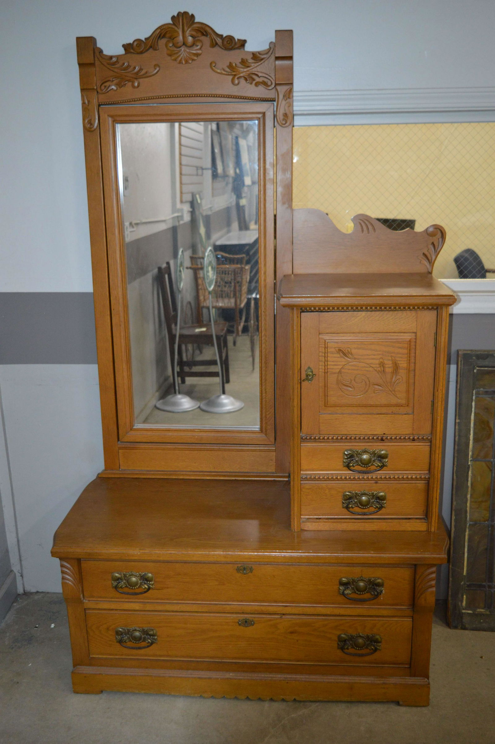 A Victorian Oak Gentleman's Dresser: A Victorian era oak gentleman's dresser, with top hat and glove compartments. Dimensions: 79.5 inches high x 42 inches x 21 inches.