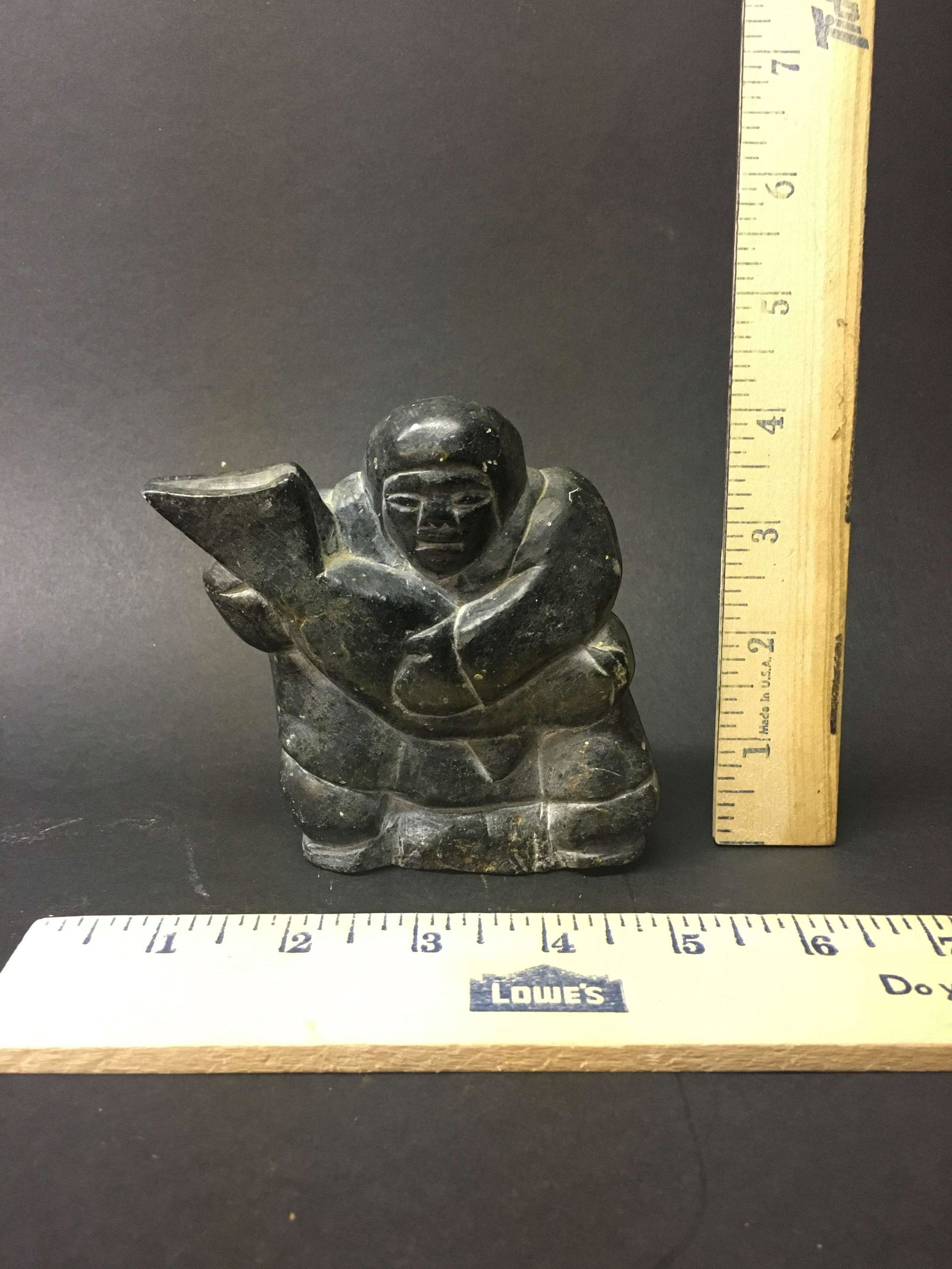 Signed Inuit Carved Soapstone Figure: A singed Inuit carved soapstone figure.