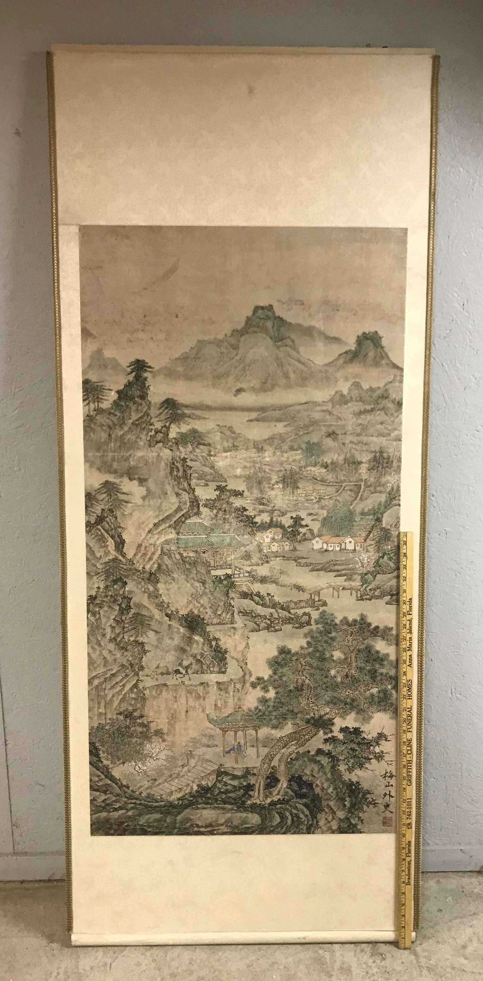 Signed Chinese Scroll Painting Mountain Landscape: A signed Chinese scroll painting depicting a mountain landscape. Mounted onto masonite board with silk trim. Dimensions: 74 inches high x 30-1/4 inches wide x 1-1/4 inches deep.