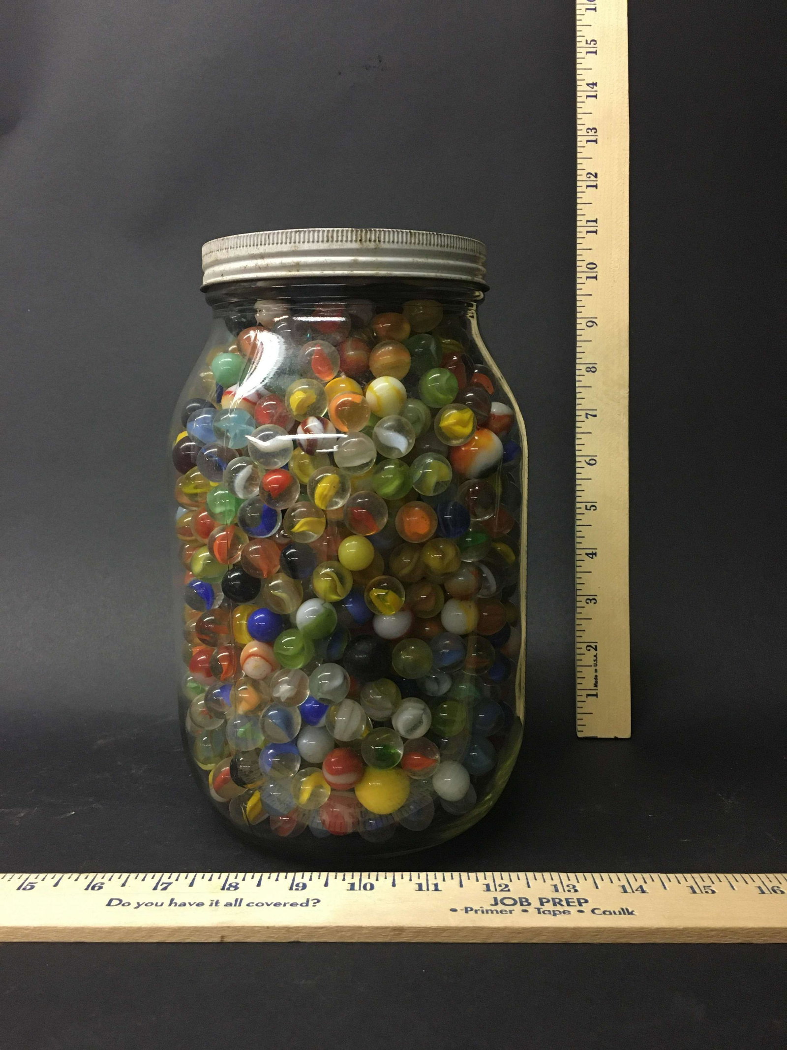Large Jar Full of Glass Marbles: A large jar full of glass marbles.
