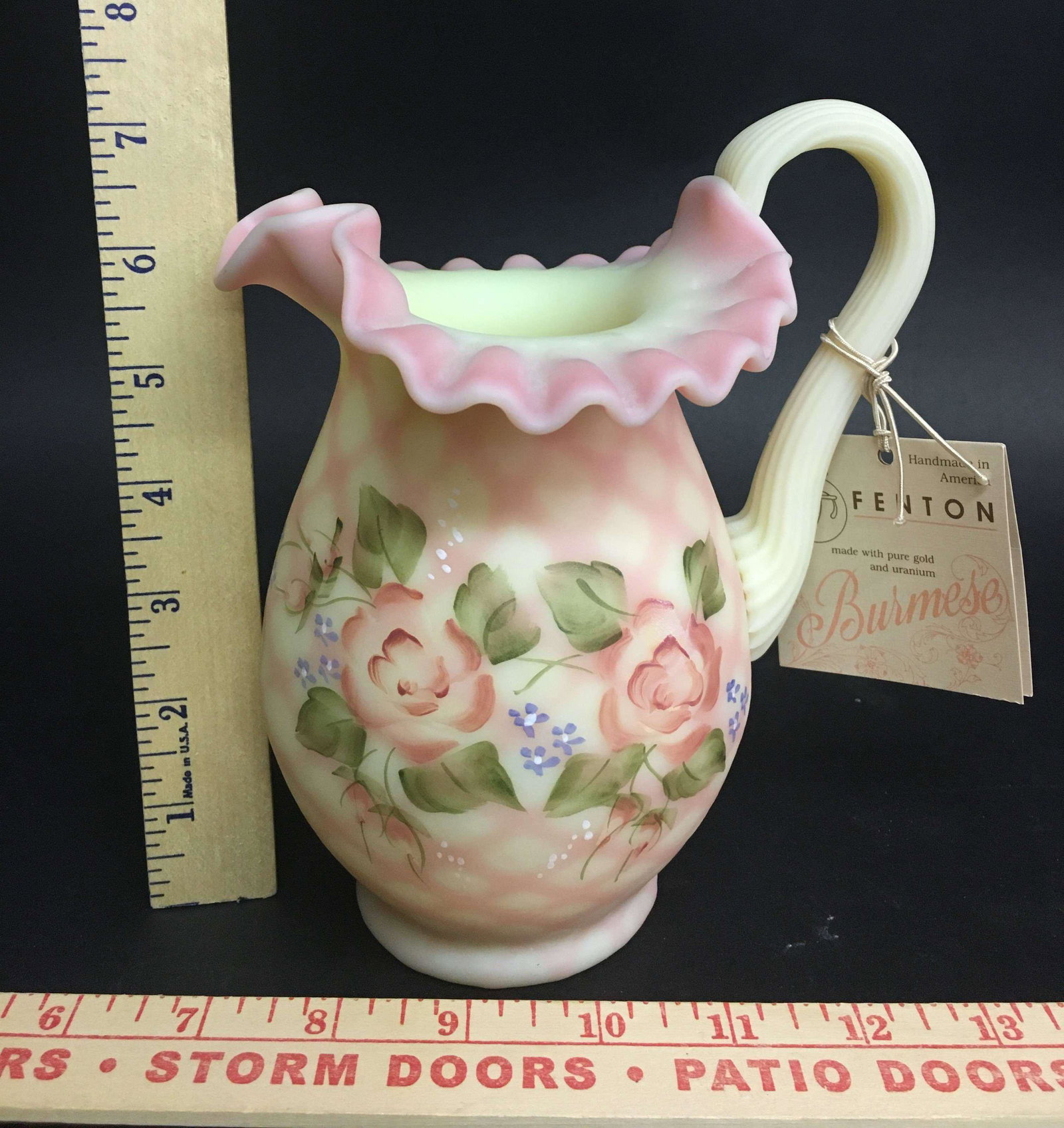 Fenton Hand Painted Burmese Glass Pitcher Artist Signed: An artist signed Fenton hand painted Burmese diamond optic glass pitcher.