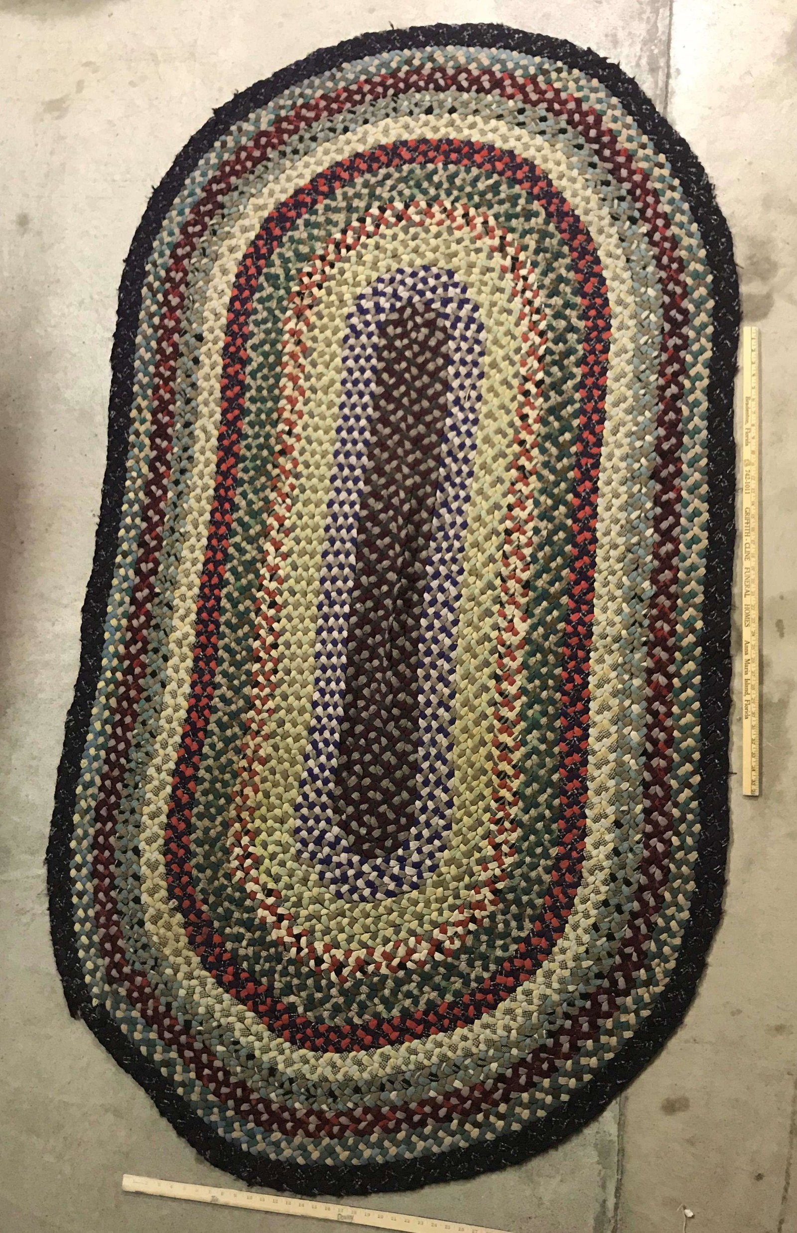 Antique Braided Rag Rug: An antique braided rag rug. Dimensions: 96 inches x 51.5 inches.