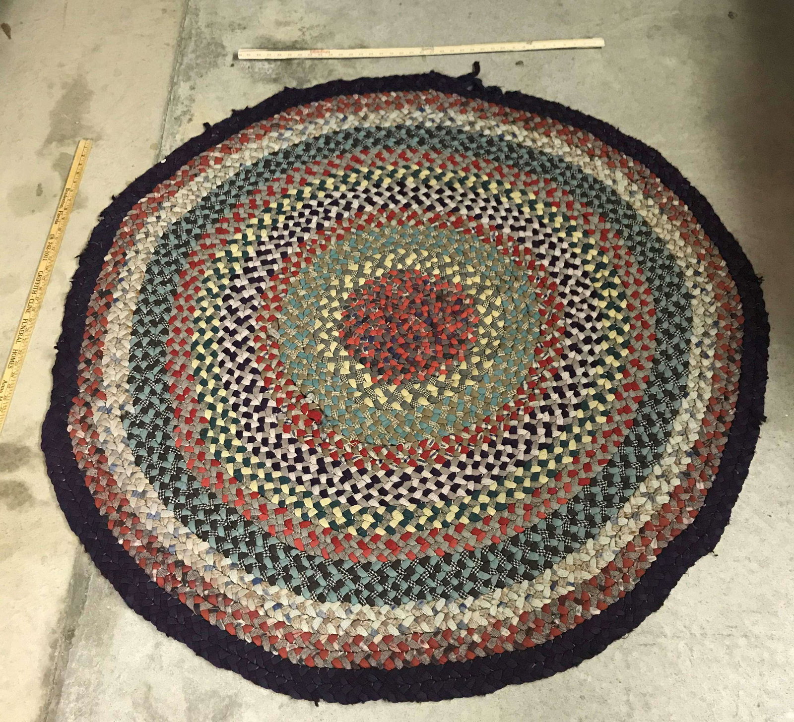Antique Braided Rag Rug: An antique braided rag rug. Dimensions: 59 inches diameter.