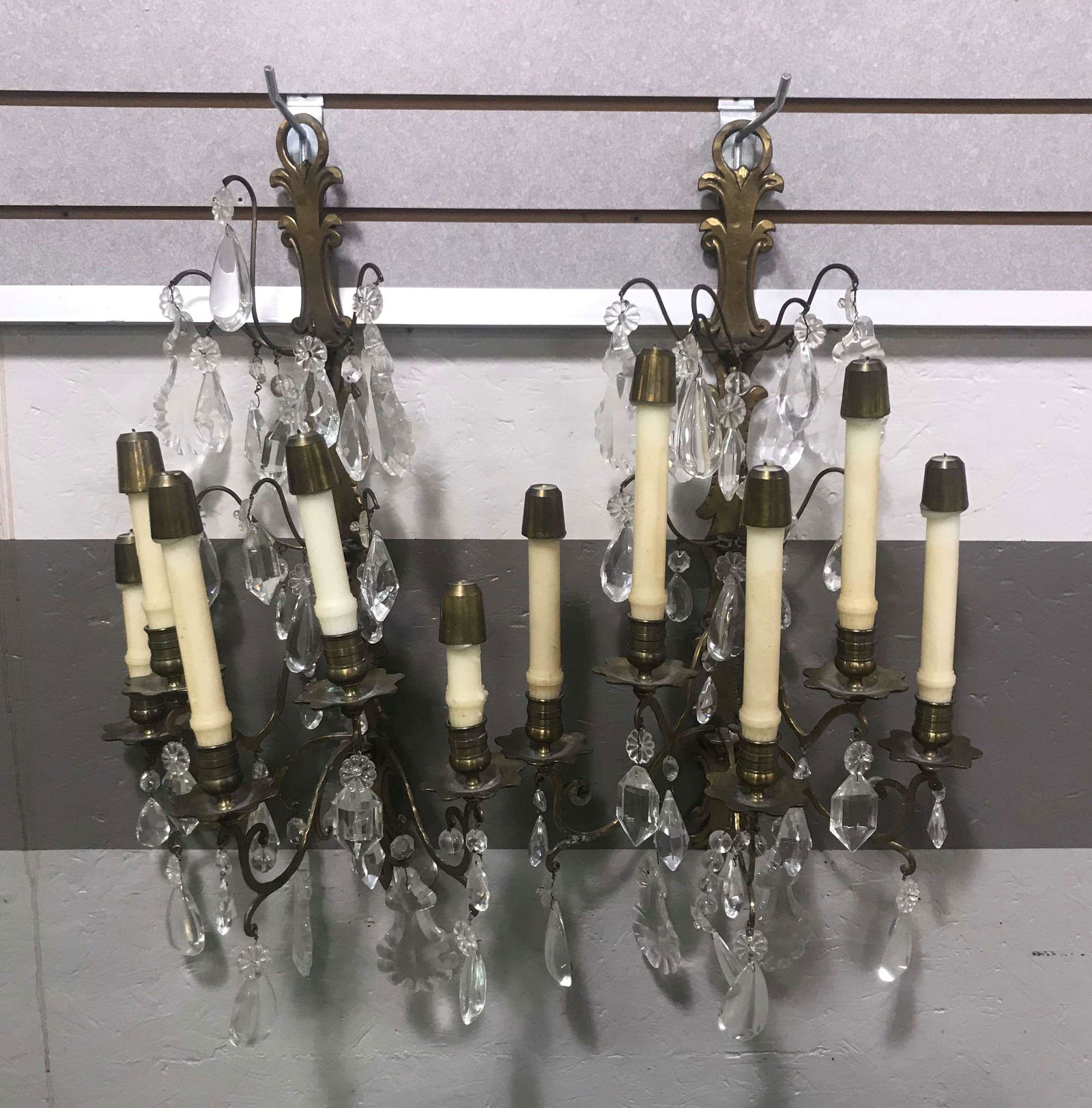 Pair Of Brass Wall Sconces w/ Crystal Prisms: A pair of brass wall sconces with crystal prisms.