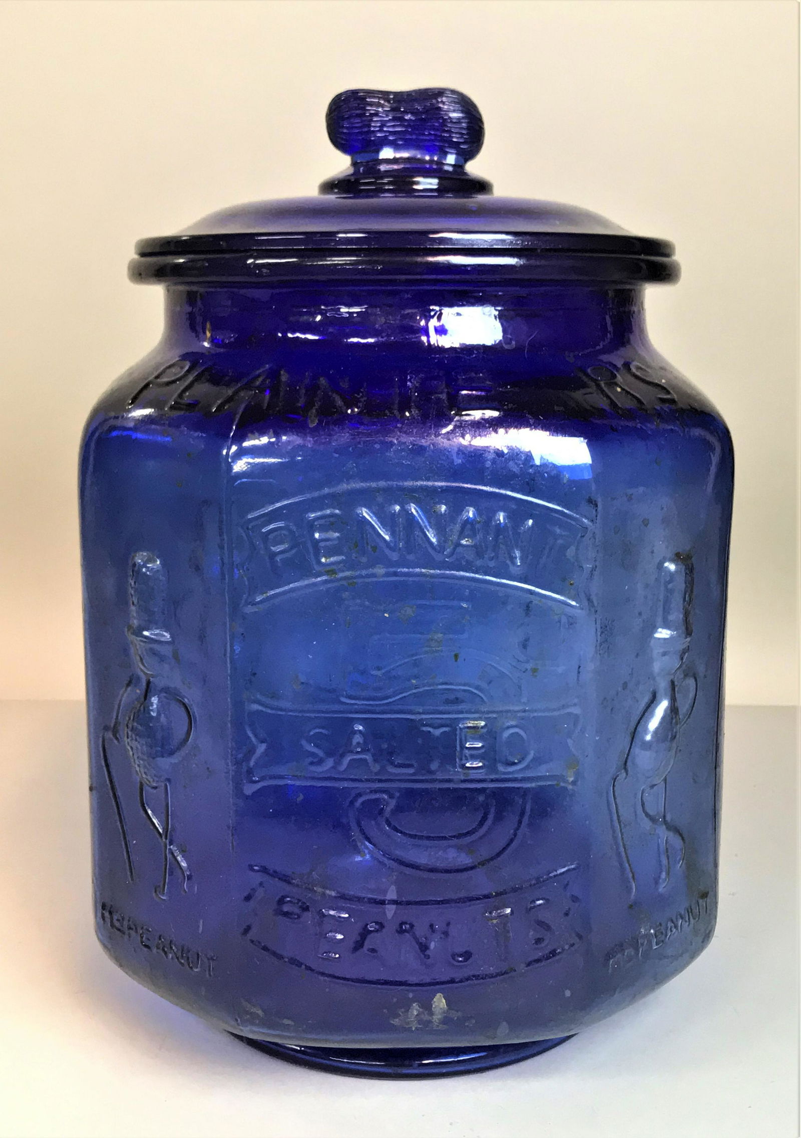 Cobalt Glass Planter's Pennant Peanuts Jar: A cobalt glass Planter's Pennant Peanuts jar.