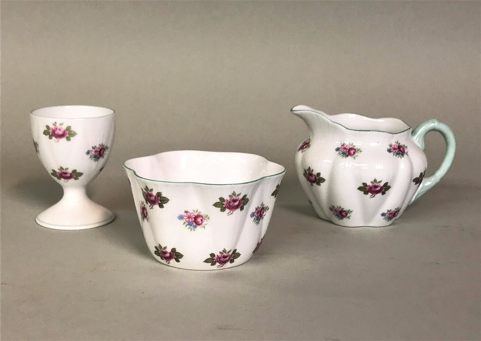 Shelley Dainty Rosebud Creamer Sugar & Egg Cup: A Shelley "Dainty" shape "Rosebud" pattern creamer, sugar, and egg cup.