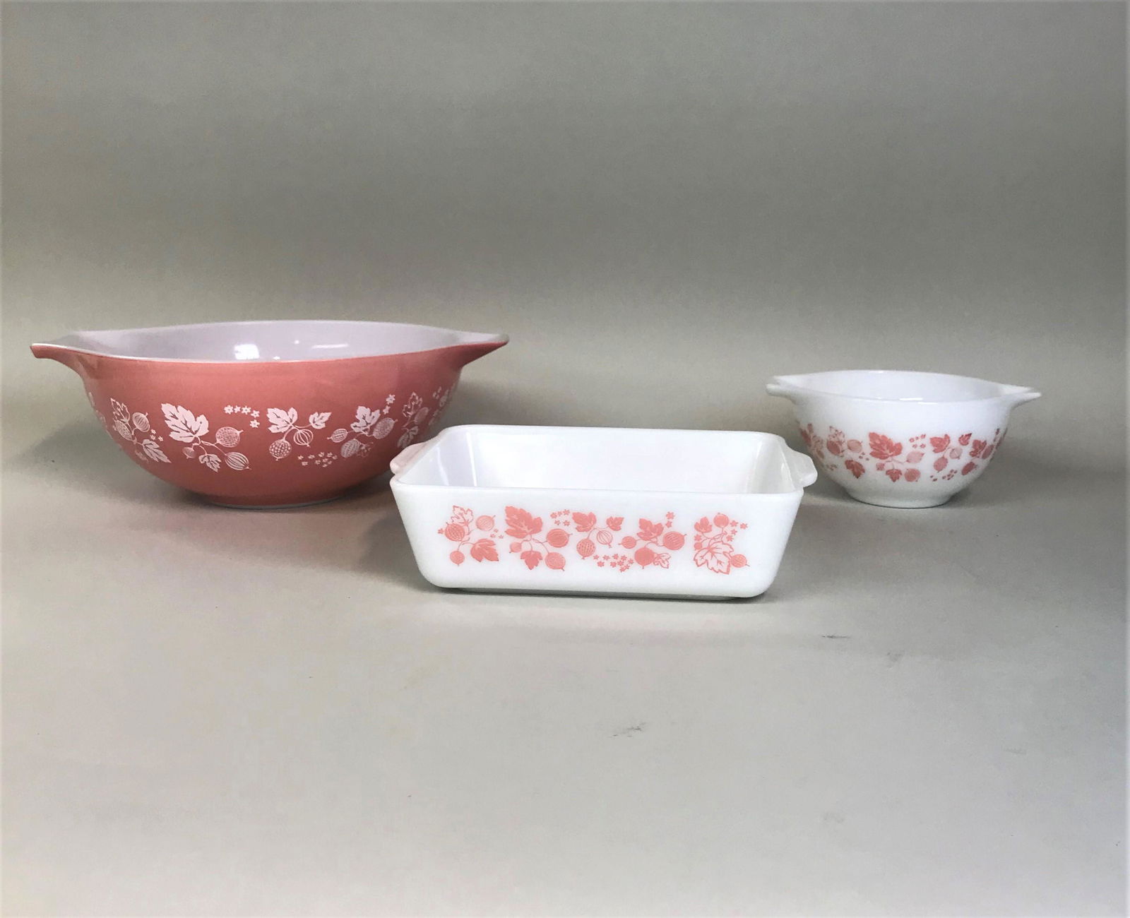 2 Pyrex Pink Gooseberry Tabbed Mixing Bowls & Baking: 2 Pyrex pink gooseberry tabbed mixing bowls and a baking dish.