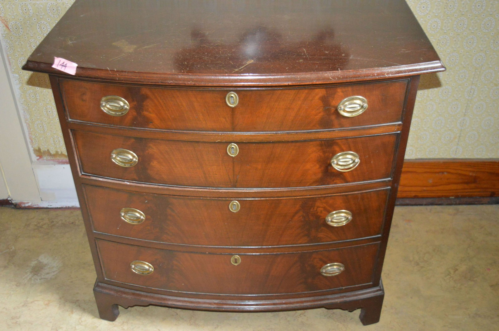 Hepplewhite style bow front mahogany chest of drawers.: Hepplewhite style bow front mahogany chest of drawers. Please review the images. Dimensions: 33.75" high x 35.5" wide x 22" deep.