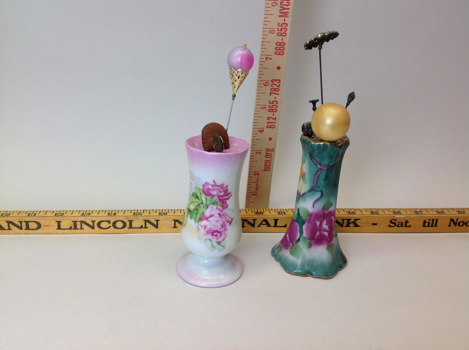 2 Porcelain Hatpin Holders w/ Hatpins: 2 porcelain hatpin holders with hatpins.