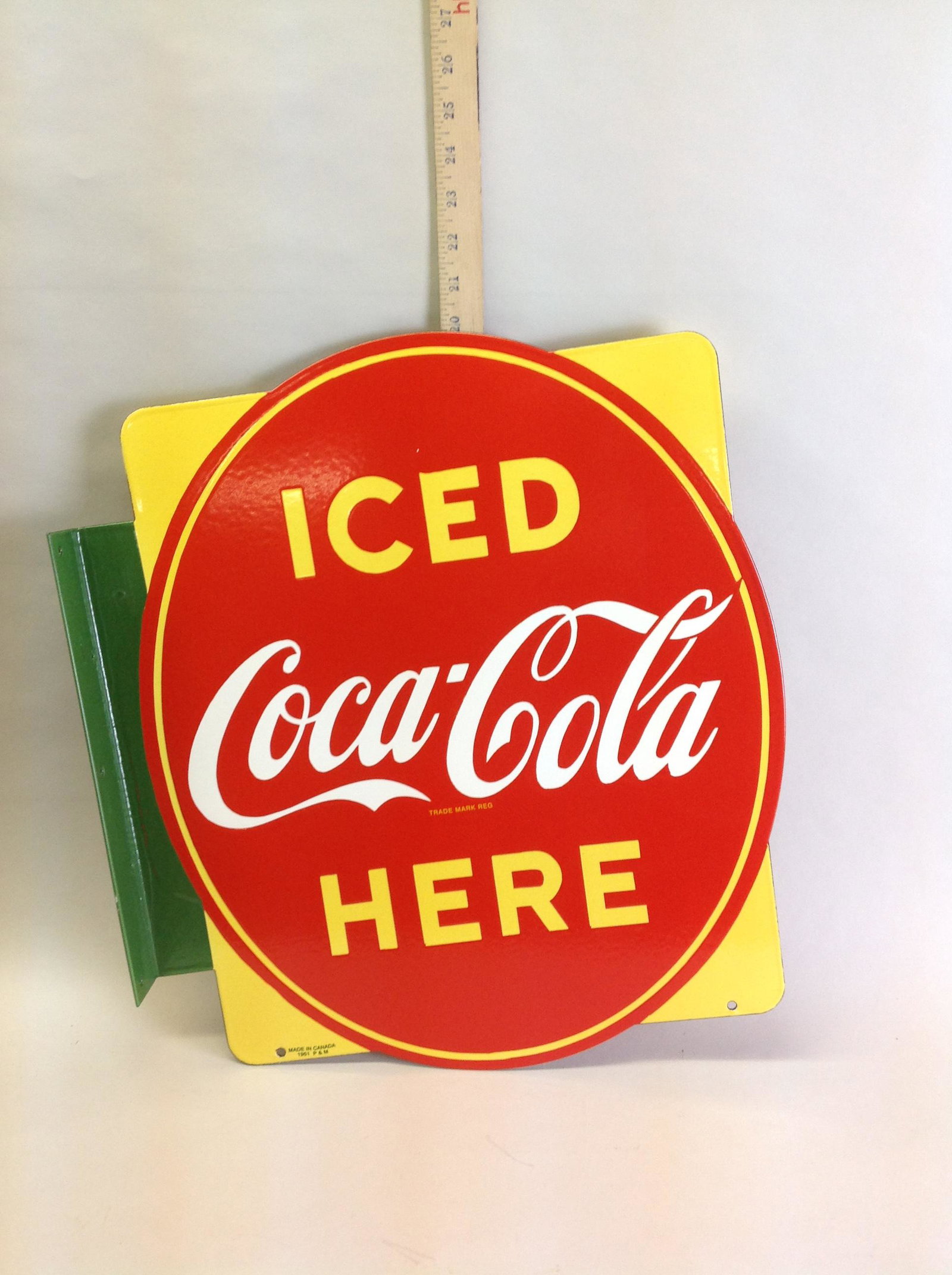 P&M Coca-Cola Double Sided Porcelain Oval Flange Sign: A P&M Coca-Cola double sided porcelain oval flange sign, circa 1951, 18" x 20 1/2"