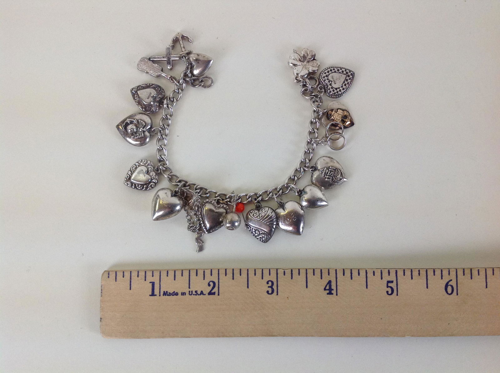 Sterling Silver Charm Bracelet: A sterling charm bracelet, weighing 31.1 grams.