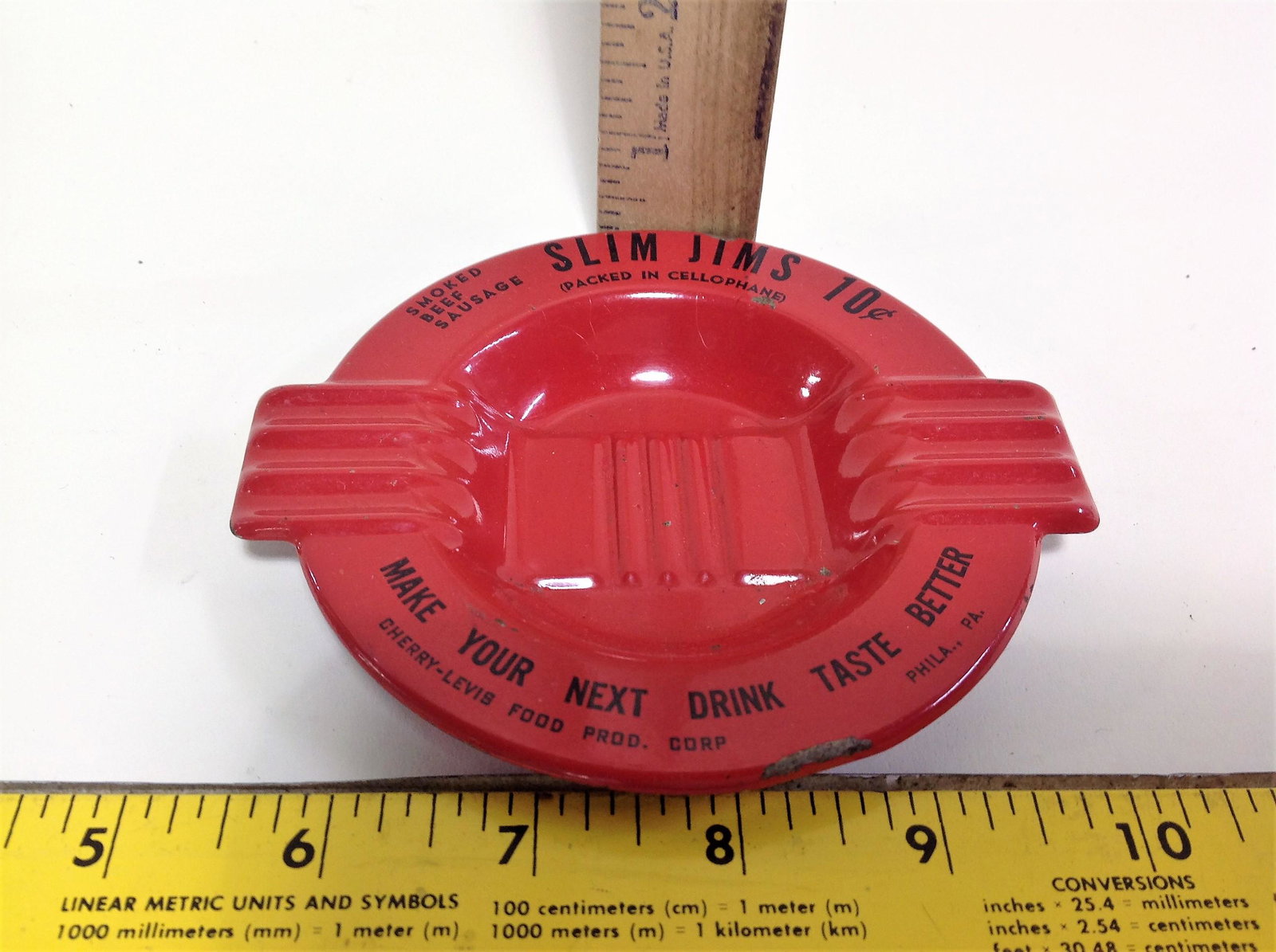 Vintage Slim Jims Enamel Metal Advertising Ashtray: A vintage Slim Jims enameled metal advertising ashtray