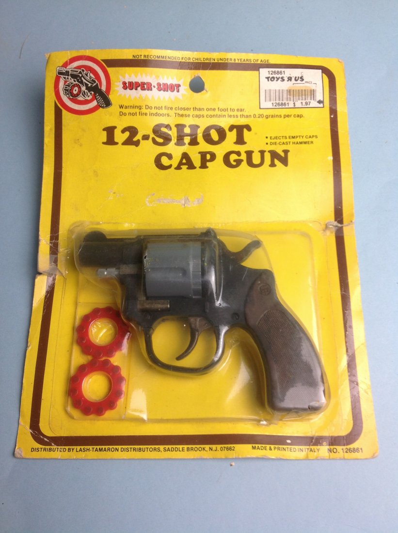 12-Shot Cap Gun, Super Shot: 12-Shot Cap Gun, Super Shot. In original Toys R Us package. Packaging is damaged. Gun is in good condition.