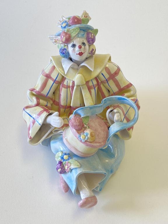 Gumps Porcelain Clown Figurine Made in Italy: Seated clown with drum figurine is 4.5"H. Figurine is dusty, but otherwise in good condition with one small chip on bottom of coat tail in back and slight wear on bottom. No other apparent chips or cr