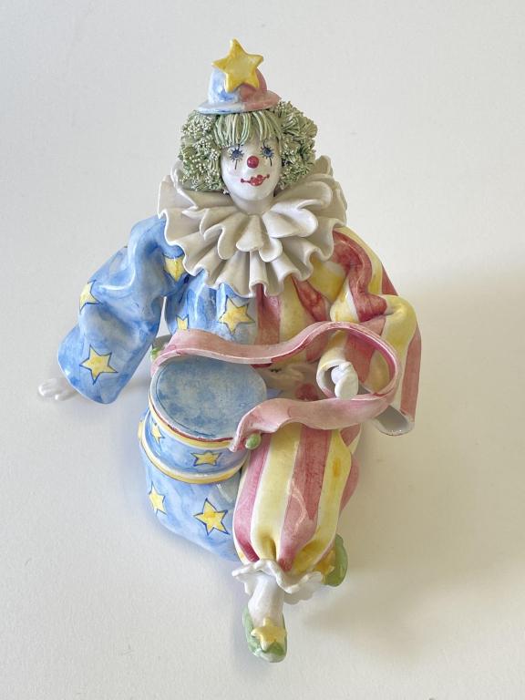Gumps Porcelain Clown Figurine Made in Italy: Seated clown with drum figurine is 4.5"H. Figurine is dusty, but otherwise in good condition with wear on bottom. No apparent chips or cracks.
