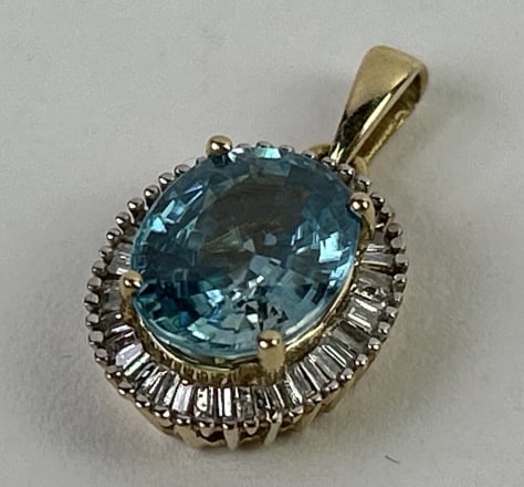 10k Gold Blue Zircon & Diamond Pendant: 10k Gold Blue Zircon & Diamond Pendant. Total weight inclusive of all materials: 2.398 grams.