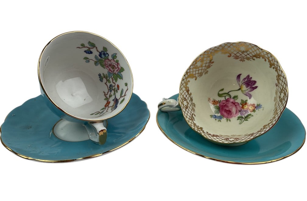 Aynsley Bone China Teacups and Matching Saucers: Aynsley bone china teacups and matching saucers in tourquoise with gold trim. Both cups have floral interior designs: one features multicolor floral and bird motifs, while the other has different colo