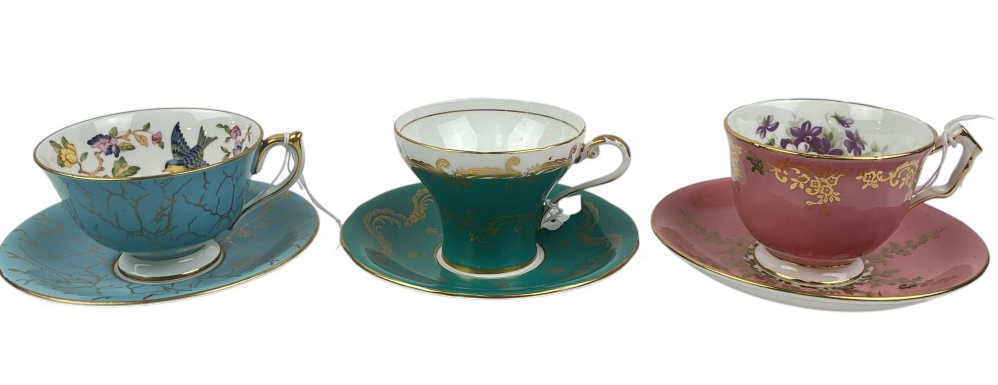 Aynsley Fine Bone China Tea Cups and Matching Saucers: Aynsley fine bone china tea cups and saucers, made in England. Includes three tea cup and saucer pairs with gold detailing and vibrant colors: turquoise with floral interior, pink with gold floral des