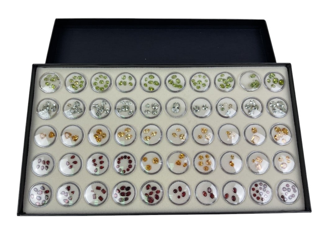 Dissplay Case of Loose Gemstones: Including garnet, citrine, and peridot.