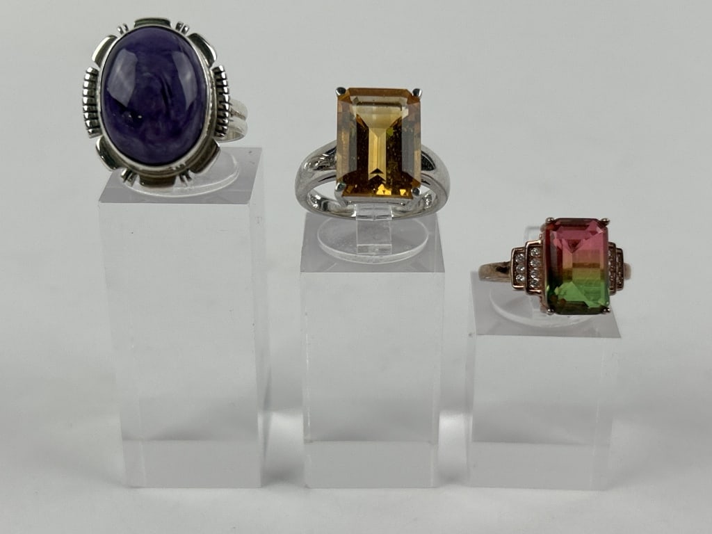 (3) Sterling Rings w/Stones: Including amethyst colored stone, watermelon colored stone, and citrine colored stone. Total weight inclusive of all materials: 14.4 grams. All size 6.75.