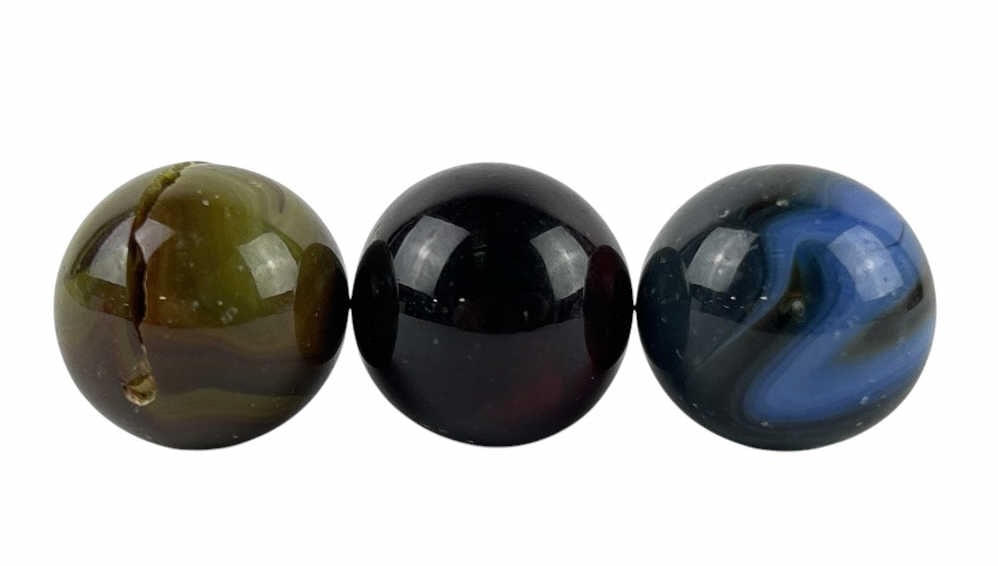 (3) Glass Glowing Shooter Marbles: (3) Glass Glowing Shooter Marbles each featuring a unique set of swirls in colors such as blue, brown, yellow, and orange. Each marble has swirls that glow under blacklight. Each marble is about 1 inc