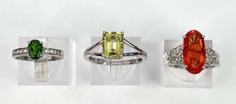 (3) 925 Sterling Rings with Yellow, Green, and Red Gemstones weighing 4.708 grams, 2.912 grams, and (1 of 5)